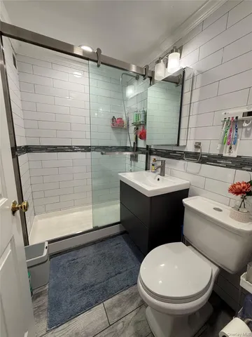 a bathroom with a sink toilet and shower