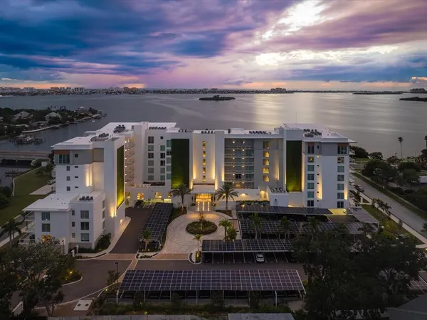a view of a house with a swimming pool and sitting area