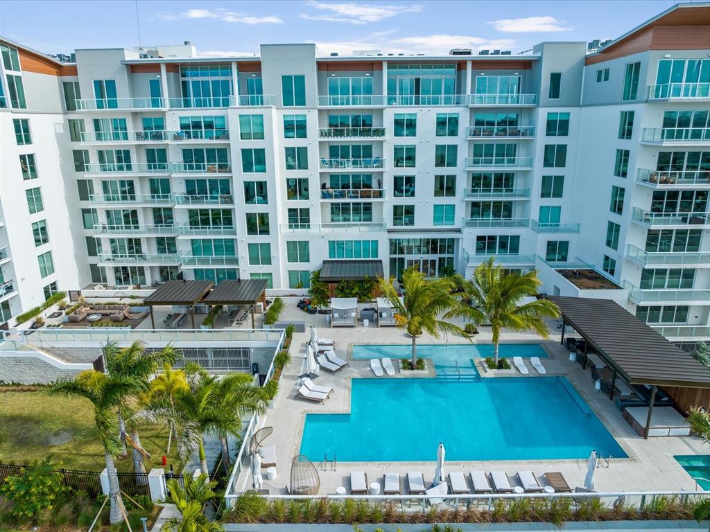 1020 Sunset Point Road, Unit 511 Clearwater, FL 33755 - Photo 12 of 93 a view of a swimming pool with outdoor seating