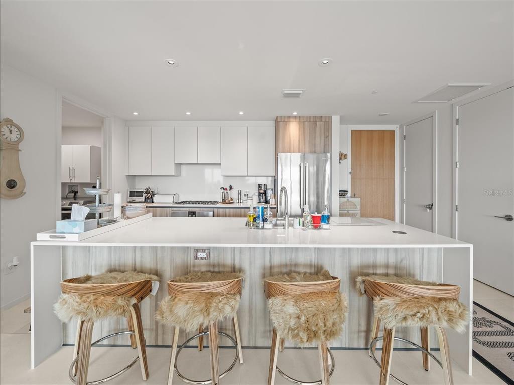 1020 Sunset Point Road, Unit 511 Clearwater, FL 33755 - Photo 20 of 93 a living room with stainless steel appliances granite countertop a dining table chairs and granite counter tops