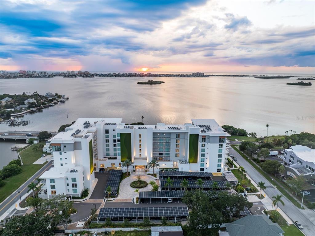 1020 Sunset Point Road, Unit 511 Clearwater, FL 33755 - Photo 2 of 93 a view of a city with lawn chairs and a large tree