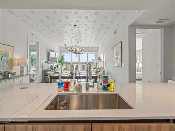 a kitchen with granite countertop white cabinets and stainless steel appliances