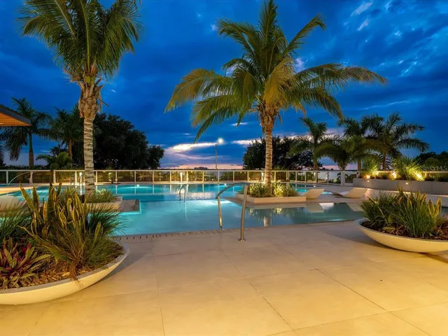 a view of swimming pool with outdoor seating and city view