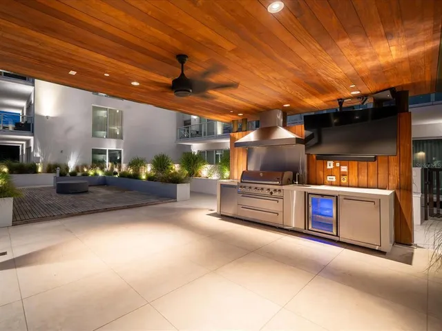 a view of a patio with couches chairs and a yard