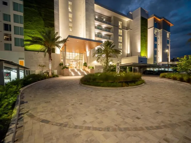 a kitchen with stainless steel appliances kitchen island granite countertop a refrigerator and a stove