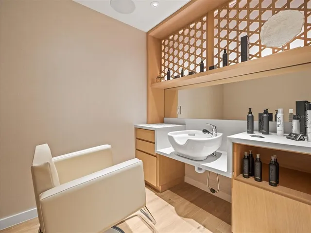 a living room with furniture a chandelier and a flat screen tv