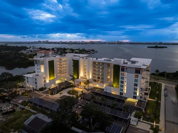 a view of a balcony with two chairs and a potted plant