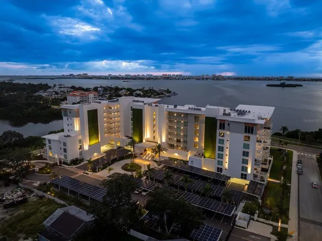 a view of a balcony with two chairs and a potted plant