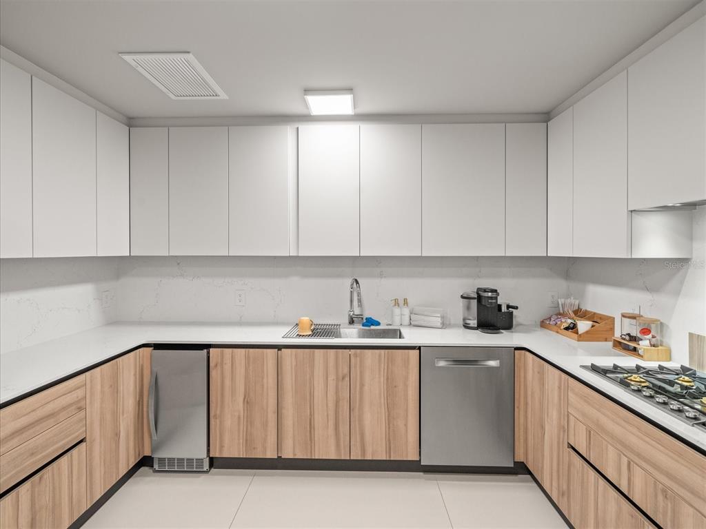 1020 Sunset Point Road, Unit 511 Clearwater, FL 33755 - Photo 50 of 93 a kitchen with a sink cabinets and a window