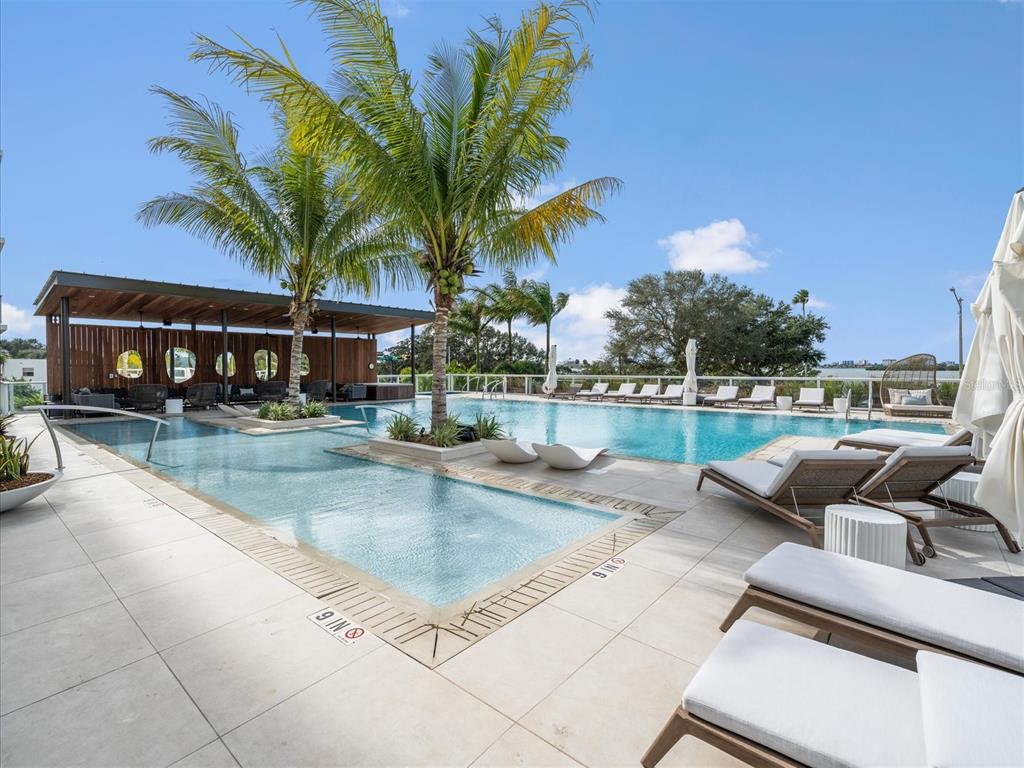 1020 Sunset Point Road, Unit 511 Clearwater, FL 33755 - Photo 55 of 93 a view of swimming pool with outdoor seating and city view