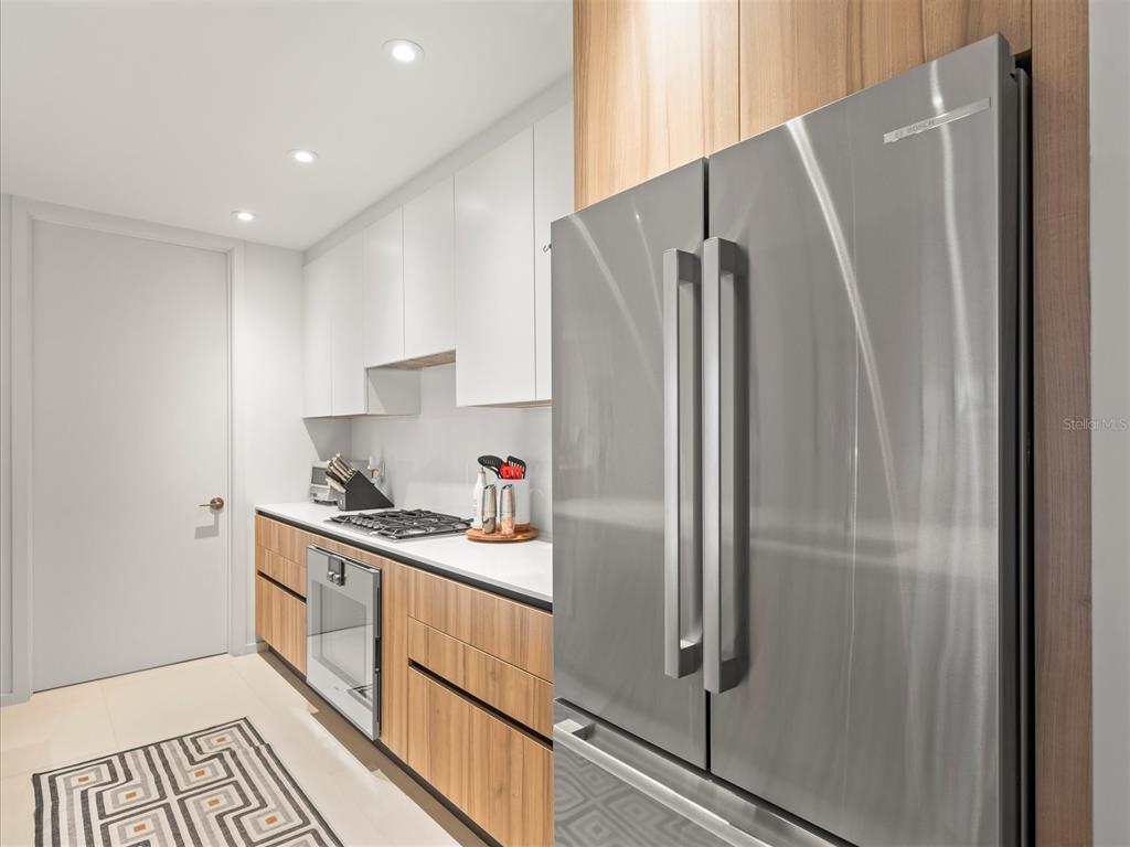 1020 Sunset Point Road, Unit 511 Clearwater, FL 33755 - Photo 63 of 93 a kitchen with stainless steel appliances a refrigerator sink and cabinets