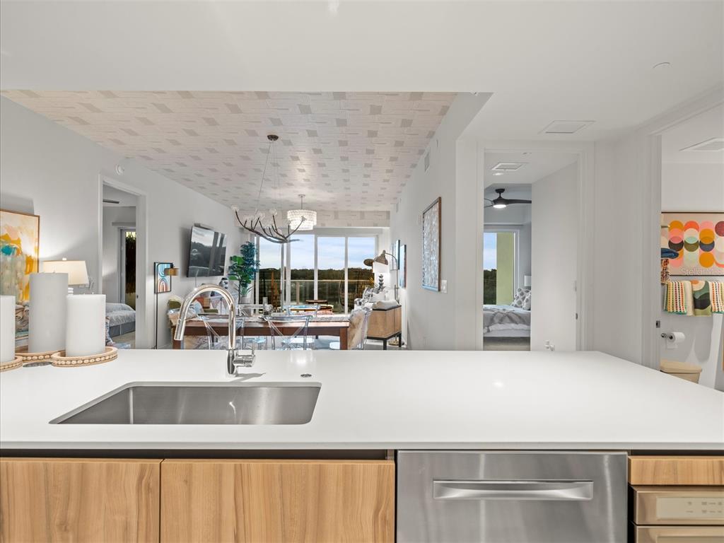 1020 Sunset Point Road, Unit 511 Clearwater, FL 33755 - Photo 64 of 93 a kitchen with a sink and a refrigerator