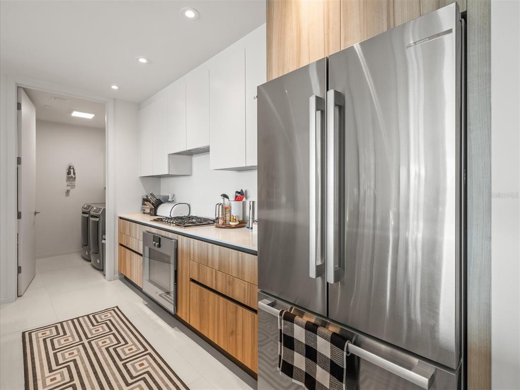 1020 Sunset Point Road, Unit 511 Clearwater, FL 33755 - Photo 66 of 93 a kitchen with granite countertop a refrigerator and a sink