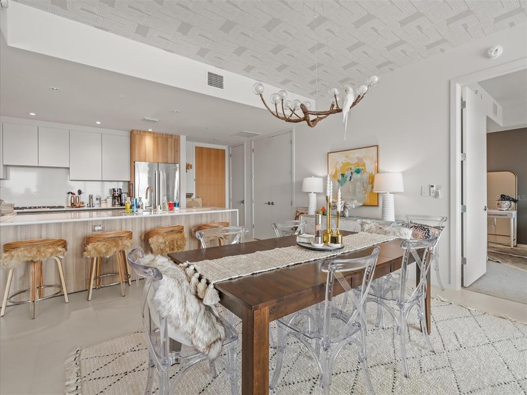 1020 Sunset Point Road, Unit 511 Clearwater, FL 33755 - Photo 70 of 93 a view of a dining room kitchen counter and chairs