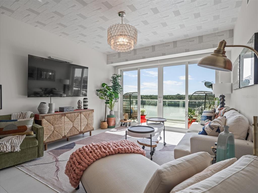1020 Sunset Point Road, Unit 511 Clearwater, FL 33755 - Photo 73 of 93 a living room with furniture and a flat screen tv