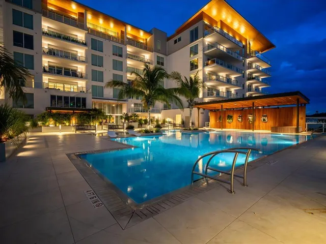 a living room with stainless steel appliances granite countertop a dining table chairs and granite counter tops