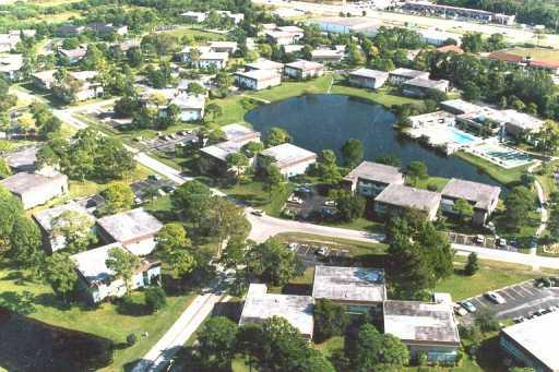 1225 Northwest 21st Street, Unit 3105 Stuart, FL 34994 - Photo 1 of 8 an aerial view of residential houses with outdoor space and swimming pool