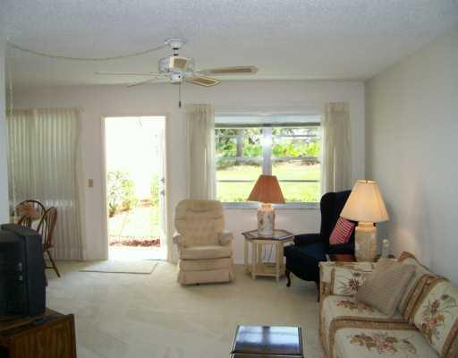 1225 Northwest 21st Street, Unit 3105 Stuart, FL 34994 - Photo 2 of 8 a living room with furniture and a large window