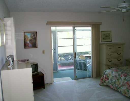 1225 Northwest 21st Street, Unit 3105 Stuart, FL 34994 - Photo 3 of 8 a living room with furniture and a window