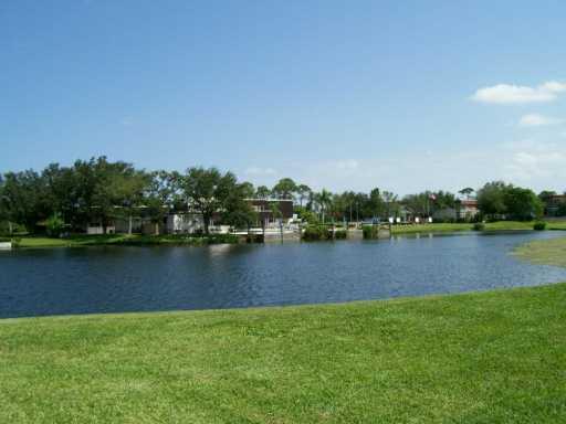 1225 Northwest 21st Street, Unit 3105 Stuart, FL 34994 - Photo 5 of 8 an aerial view of a house with a yard and outdoor seating
