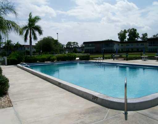 1225 Northwest 21st Street, Unit 3105 Stuart, FL 34994 - Photo 8 of 8 a view of a swimming pool and lounge chair