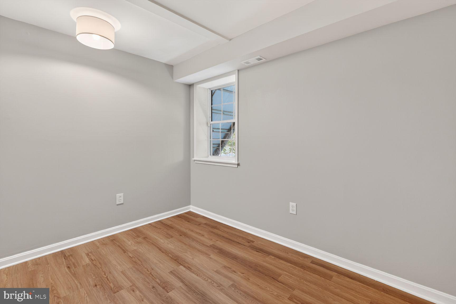 1008 Rittenhouse Street Northwest, Unit 15 Washington, DC 20011 - Photo 36 of 39 a view of room with wooden floor and fan