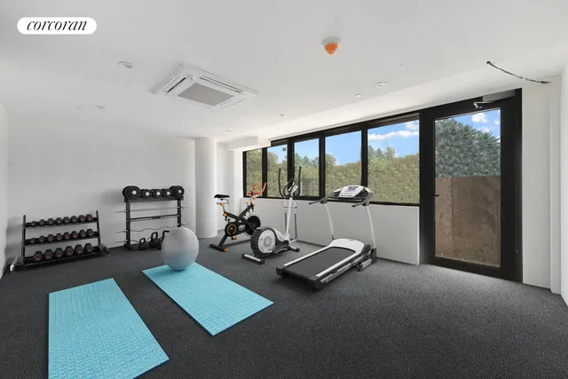 a room with gym equipment and a large window