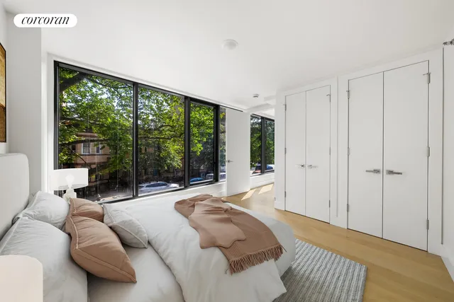 a bed room with a bed and a large window