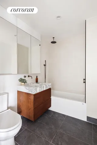 a bathroom with a sink mirror vanity and toilet
