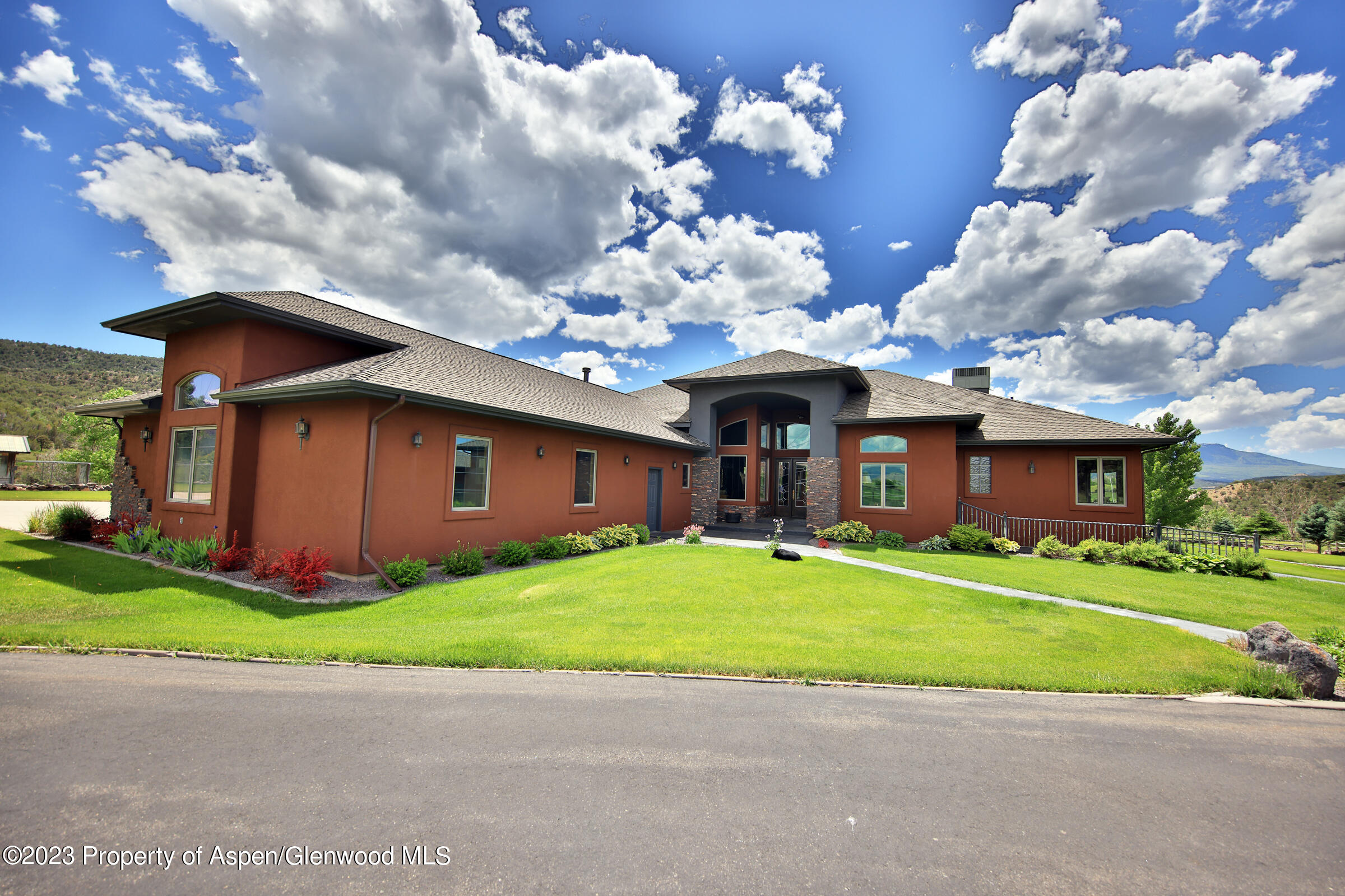52962 KE Road Molina, CO 81646 - Photo 1 of 46 a front view of a house with a yard and a garage