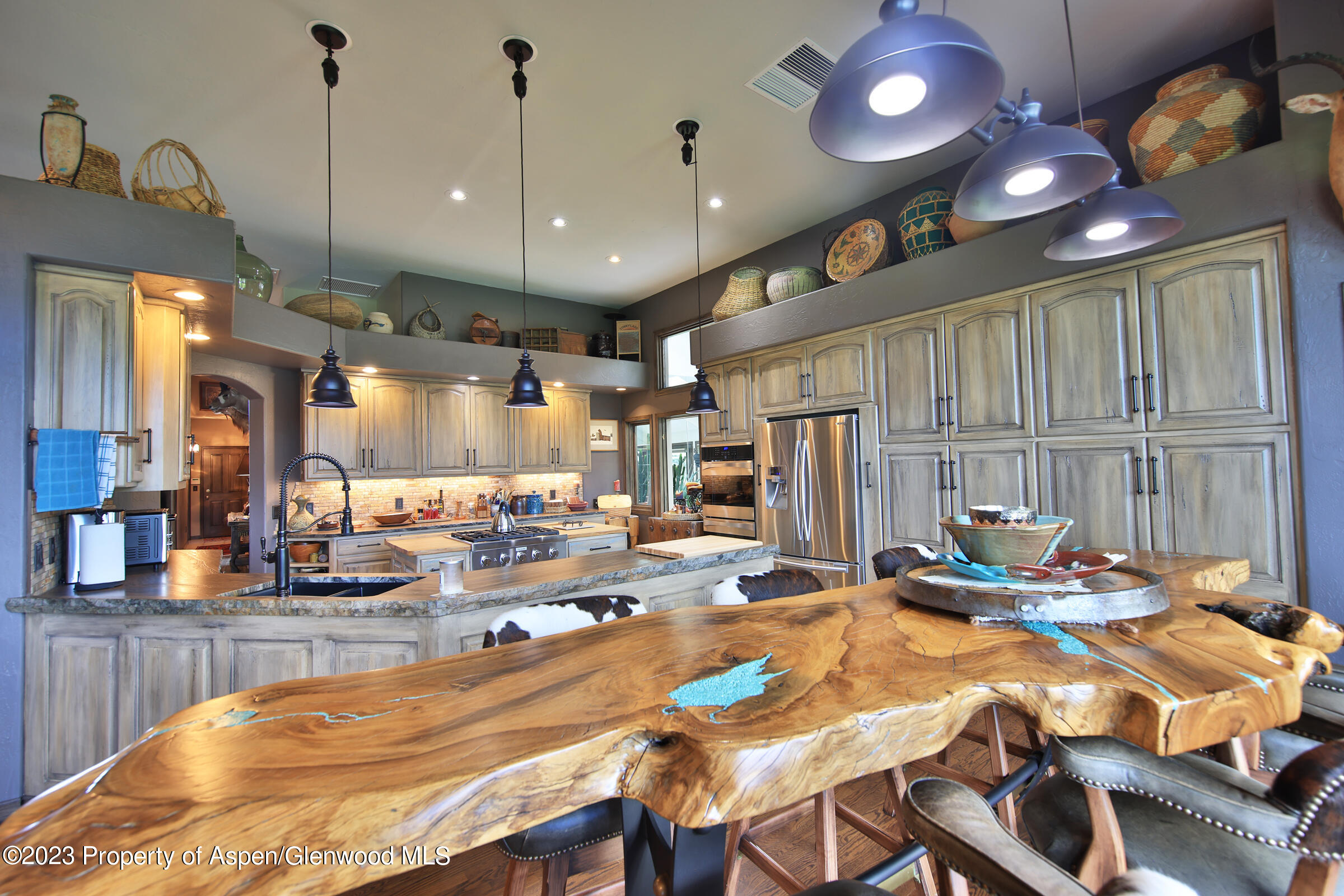 52962 KE Road Molina, CO 81646 - Photo 11 of 46 a room with stainless steel appliances kitchen island granite countertop furniture and a kitchen view