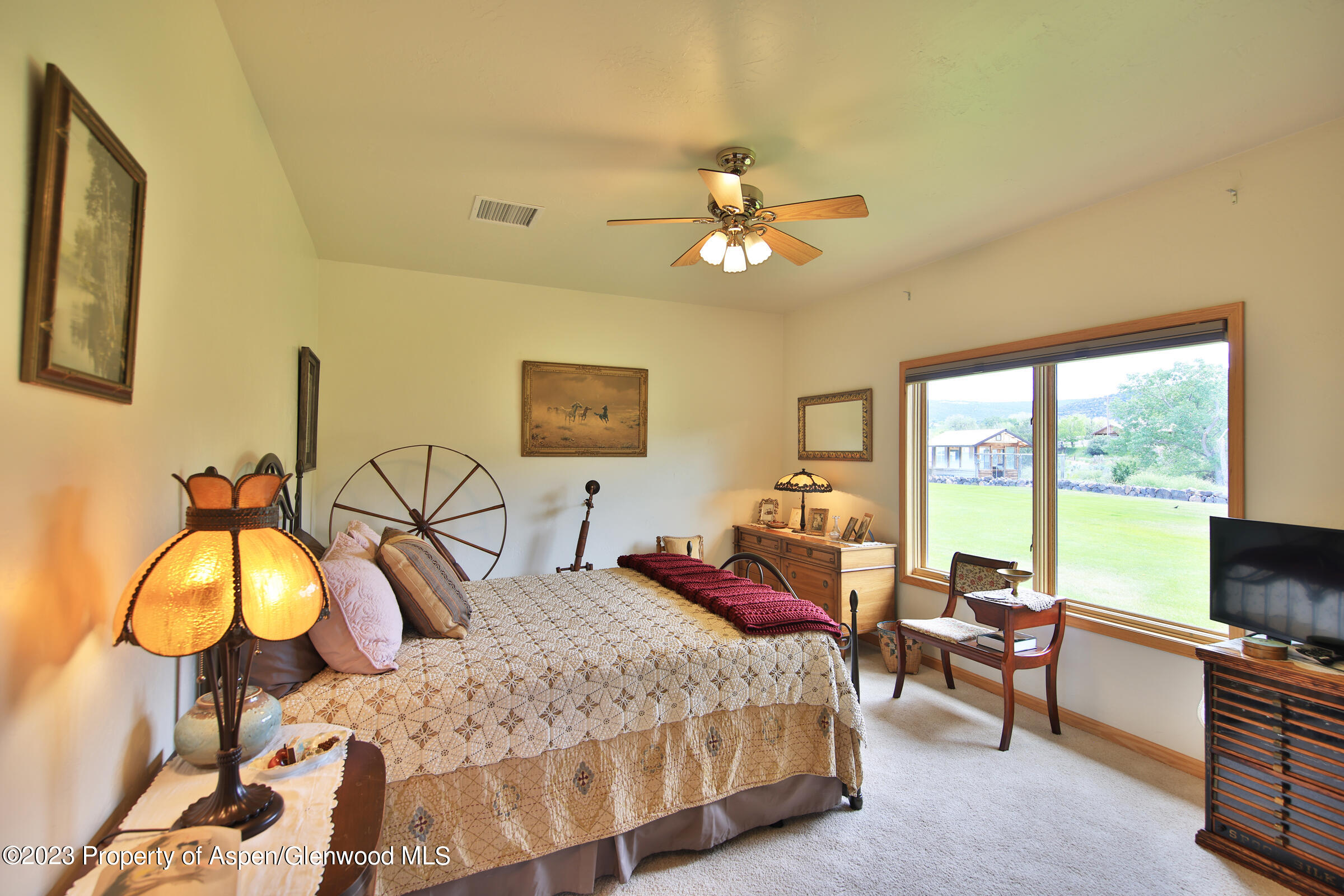 52962 KE Road Molina, CO 81646 - Photo 20 of 46 a bedroom with a bed and a chandelier