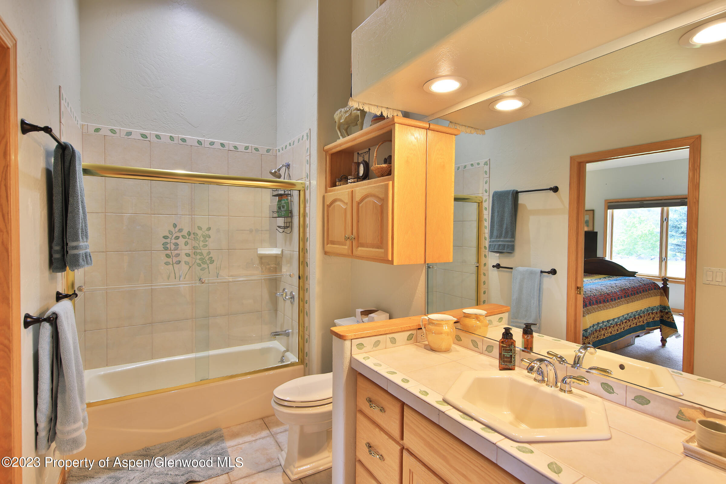 52962 KE Road Molina, CO 81646 - Photo 22 of 46 a bathroom with a granite countertop sink toilet mirror and shower