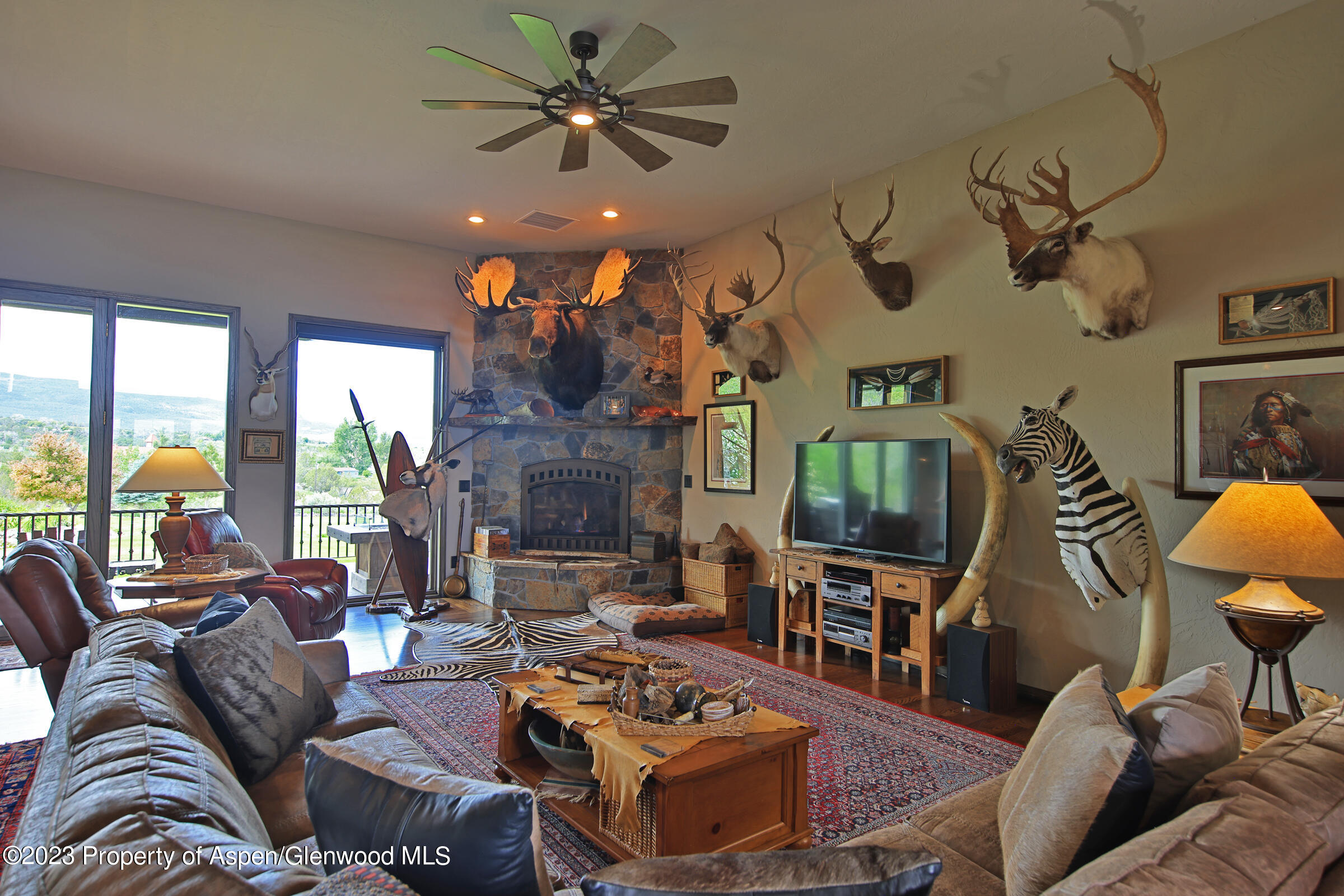 52962 KE Road Molina, CO 81646 - Photo 6 of 46 a living room with furniture a fireplace and a flat screen tv