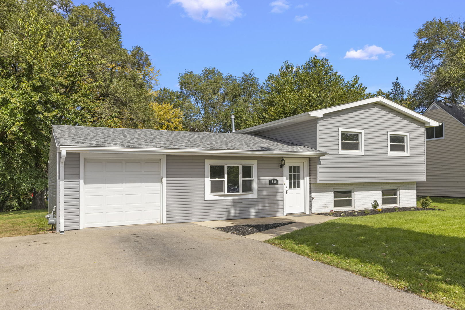 530 East Briarcliff Road Bolingbrook, IL 60440 - Photo 1 of 19 a front view of a house with a garden and yard