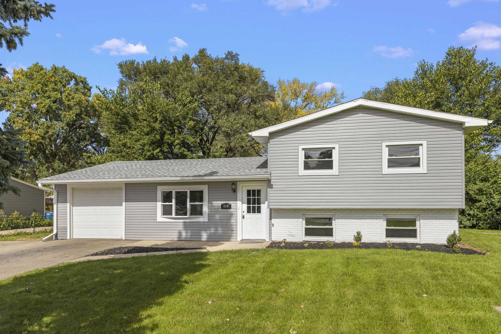 530 East Briarcliff Road Bolingbrook, IL 60440 - Photo 2 of 19 a front view of a house with a yard