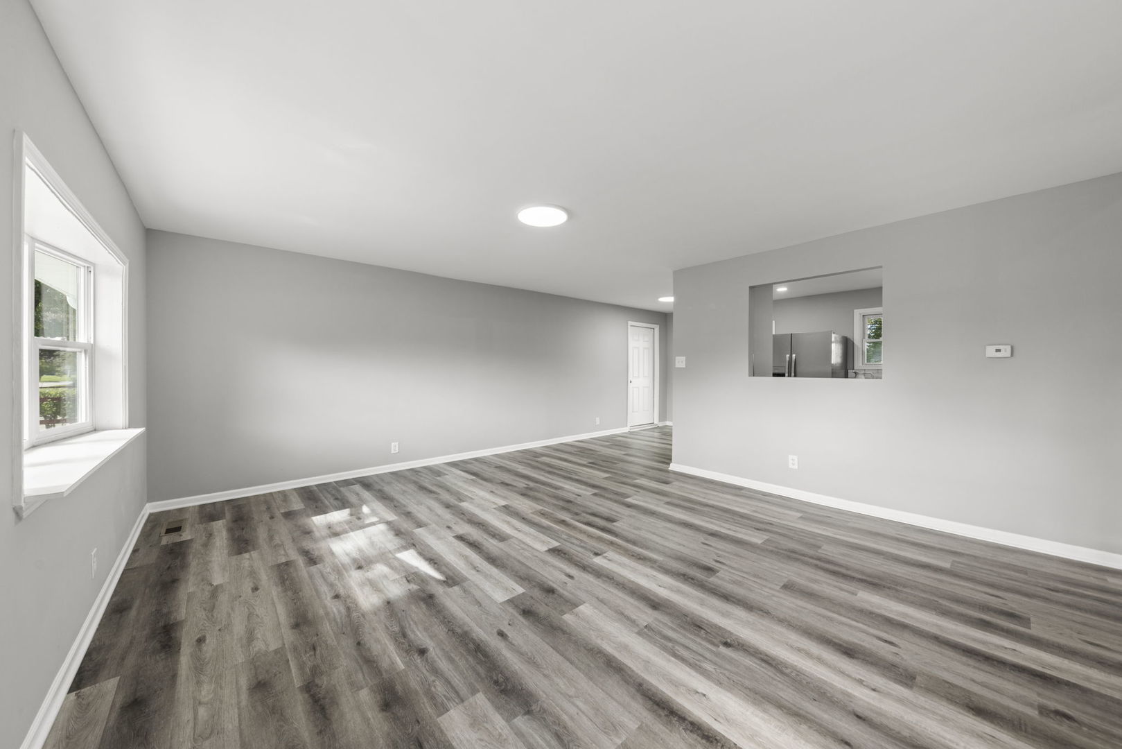 530 East Briarcliff Road Bolingbrook, IL 60440 - Photo 3 of 19 a view of empty room with wooden floor and fan