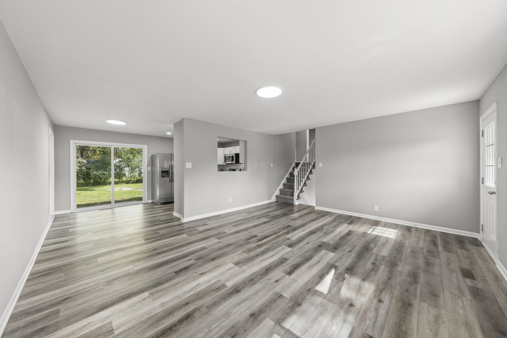 530 East Briarcliff Road Bolingbrook, IL 60440 - Photo 4 of 19 a view of empty room with wooden floor and fan