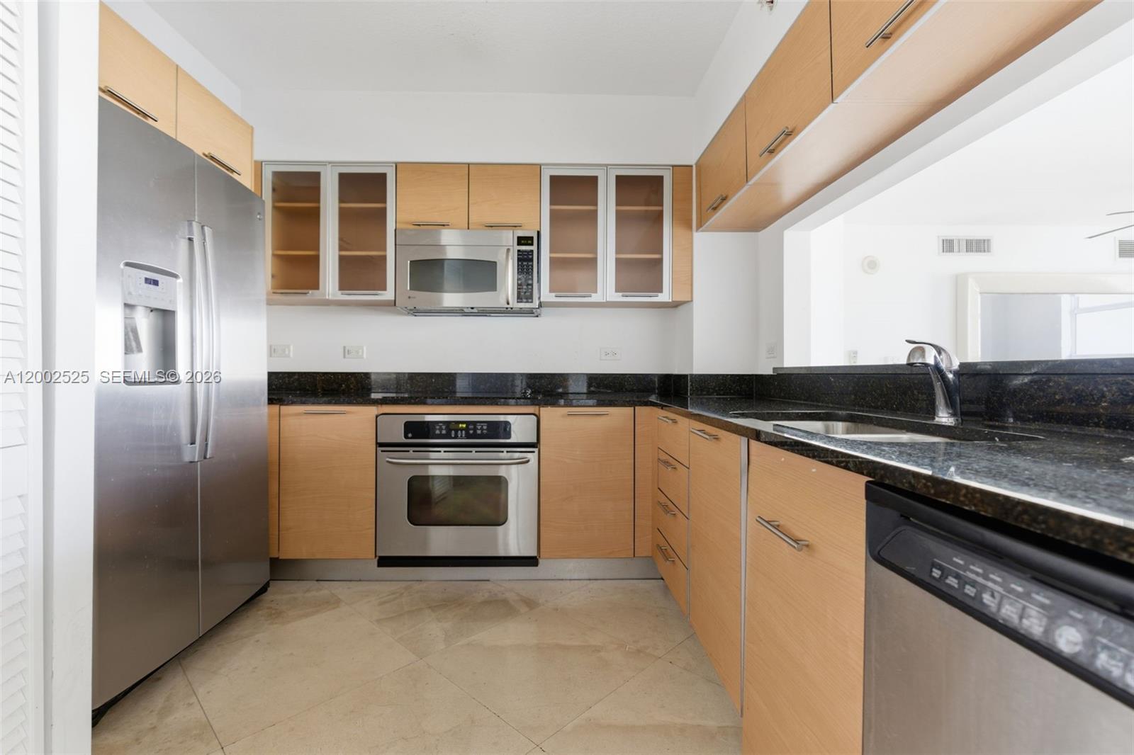 31 Southeast 5th Street, Unit 2301 Miami, FL 33131 - Photo 17 of 50 a kitchen with a stove sink and refrigerator