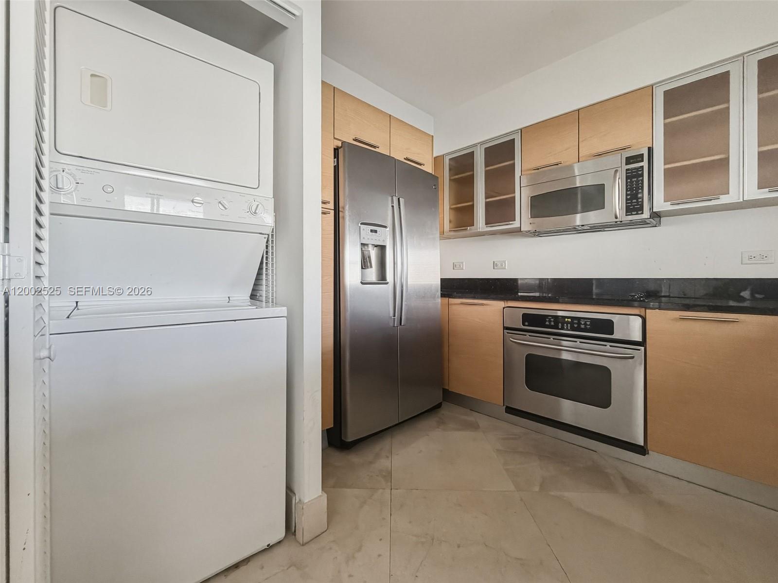 31 Southeast 5th Street, Unit 2301 Miami, FL 33131 - Photo 19 of 50 a kitchen with cabinets and stainless steel appliances