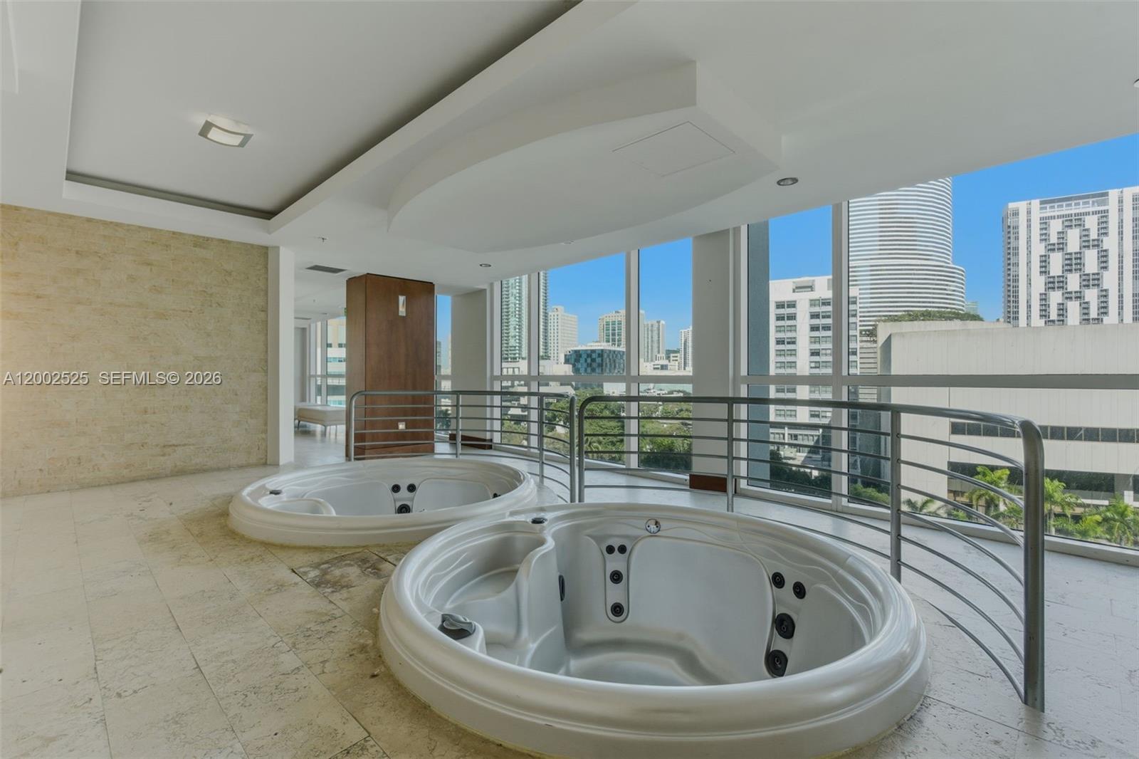 31 Southeast 5th Street, Unit 2301 Miami, FL 33131 - Photo 33 of 50 a bathroom with a bathtub and sink