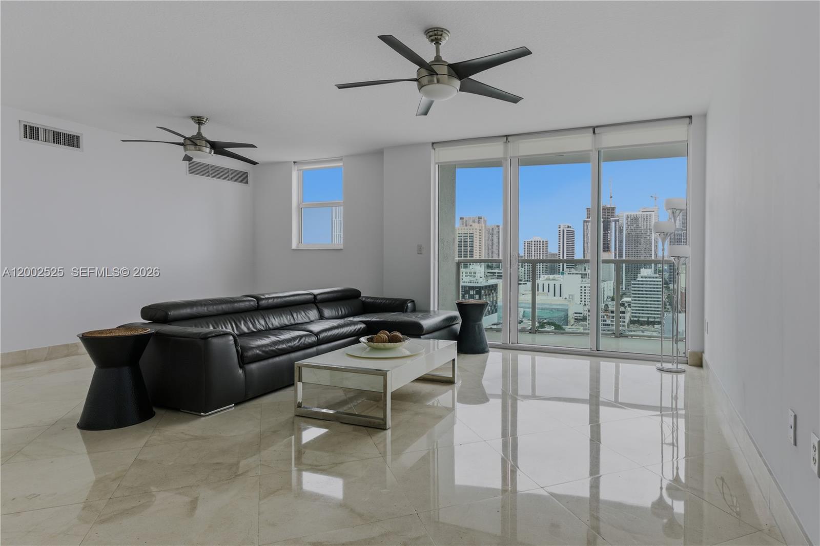 31 Southeast 5th Street, Unit 2301 Miami, FL 33131 - Photo 6 of 50 a kitchen with a table chairs refrigerator and cabinets