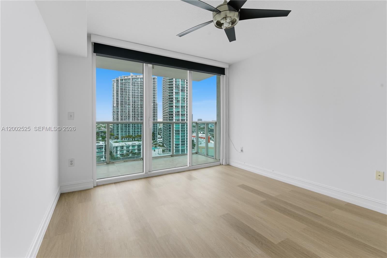 31 Southeast 5th Street, Unit 2301 Miami, FL 33131 - Photo 9 of 50 a view of a livingroom with a ceiling fan and window