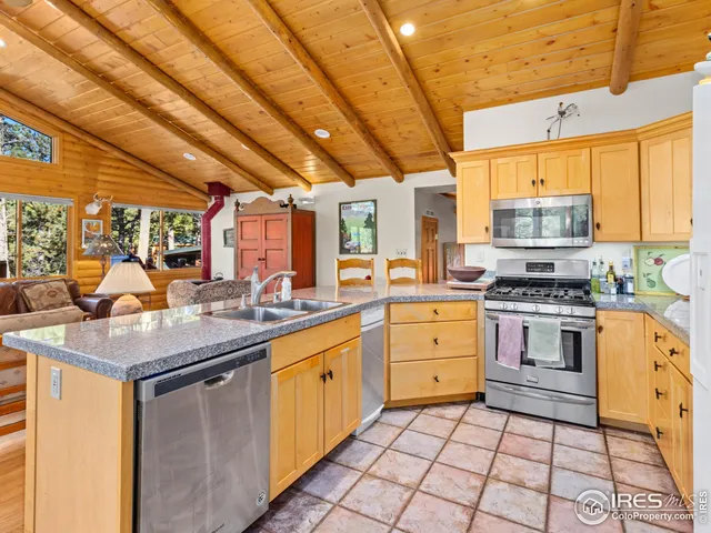 a kitchen with stainless steel appliances a stove sink and cabinets