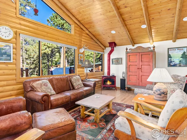 a bedroom with furniture and a large window