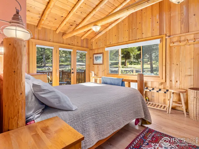 a living room with furniture and floor to ceiling windows