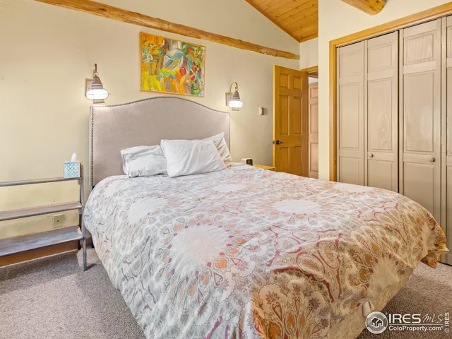 a bedroom with a bed and a painting on the wall