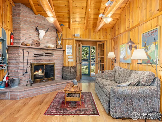 a living room with furniture a rug and a fireplace