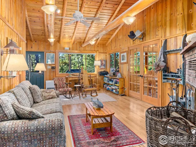 a living room with furniture a wooden floor and next to a window
