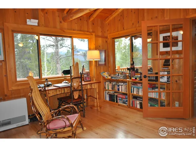a living room with furniture a large window and floor to ceiling windows